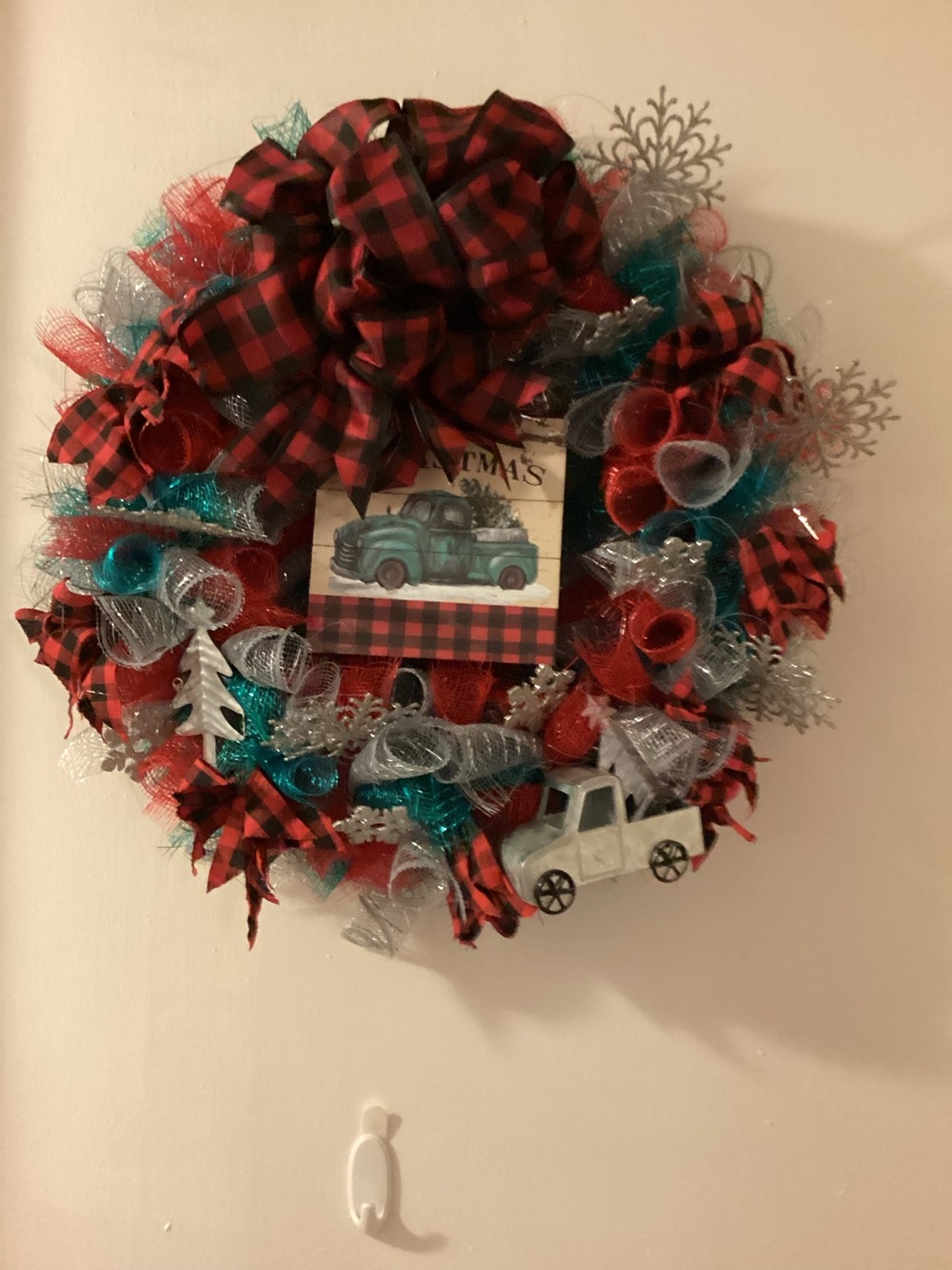 Homemade Christmas wreath with blue truck and black and red bow